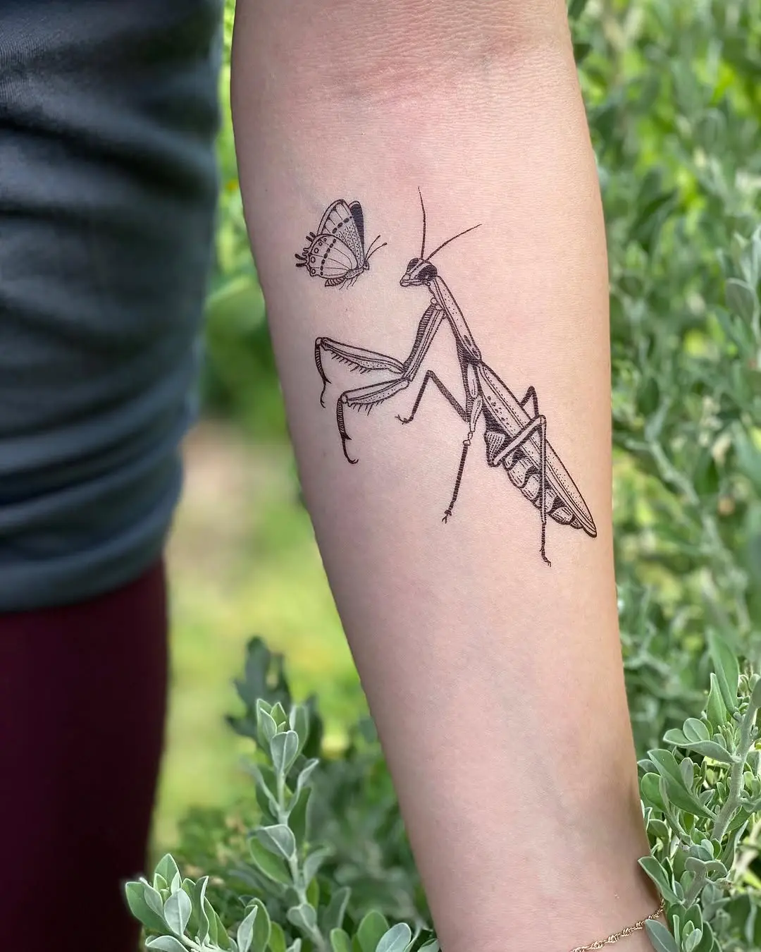 Intricate praying mantis tattoo with butterfly