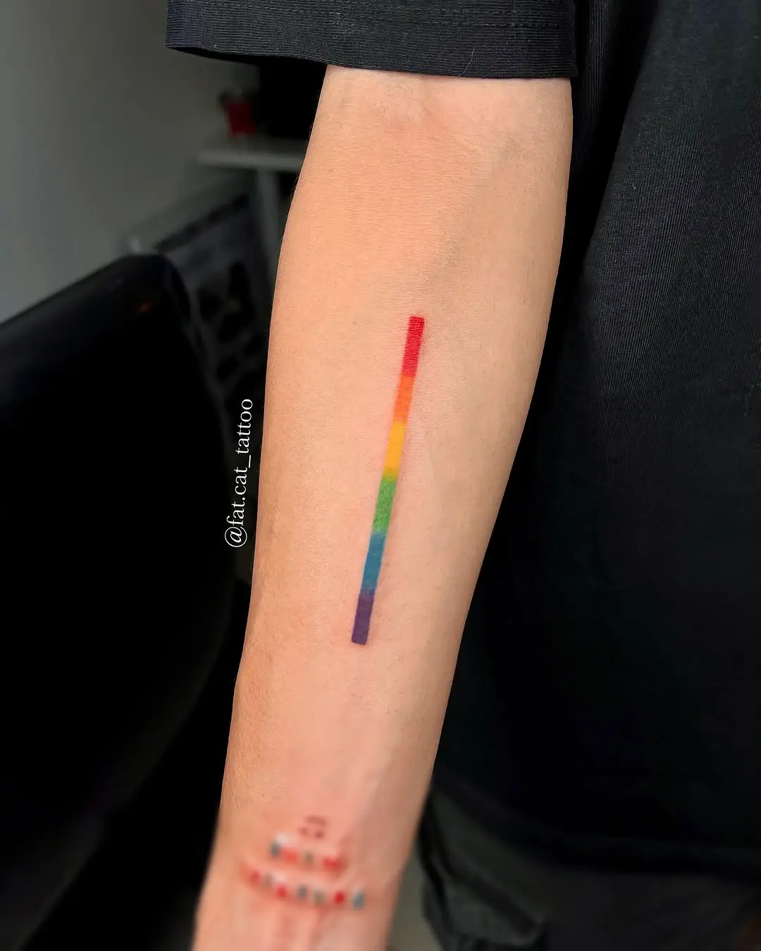 Vibrant Rainbow Stripe Tattoo on Forearm