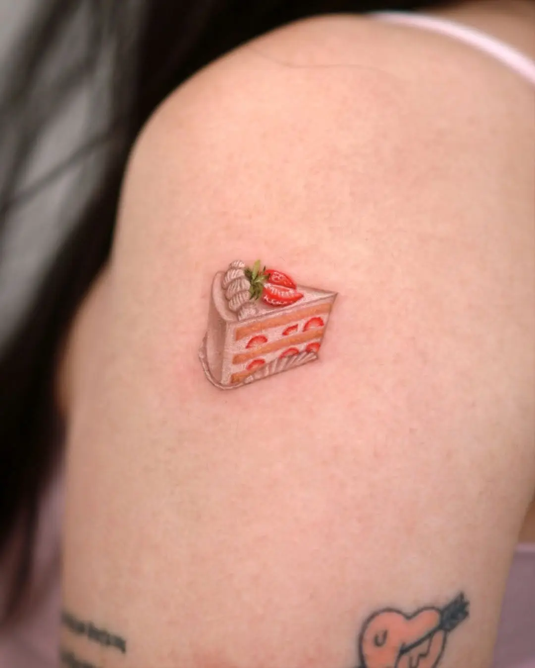 Charming strawberry cake tattoo design on skin