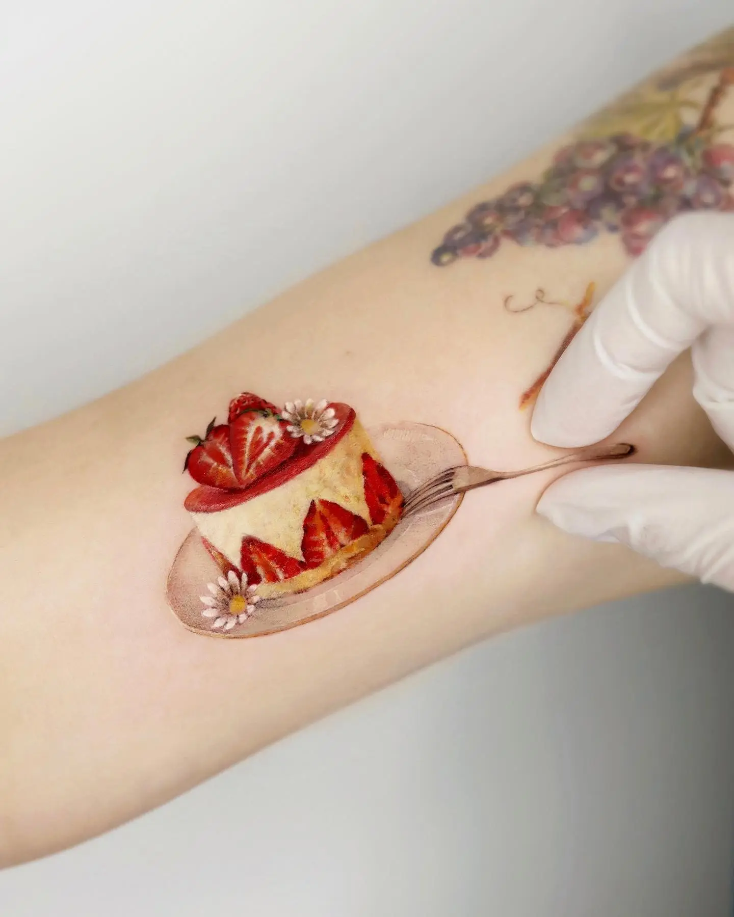 Charming strawberry cake tattoo design on skin