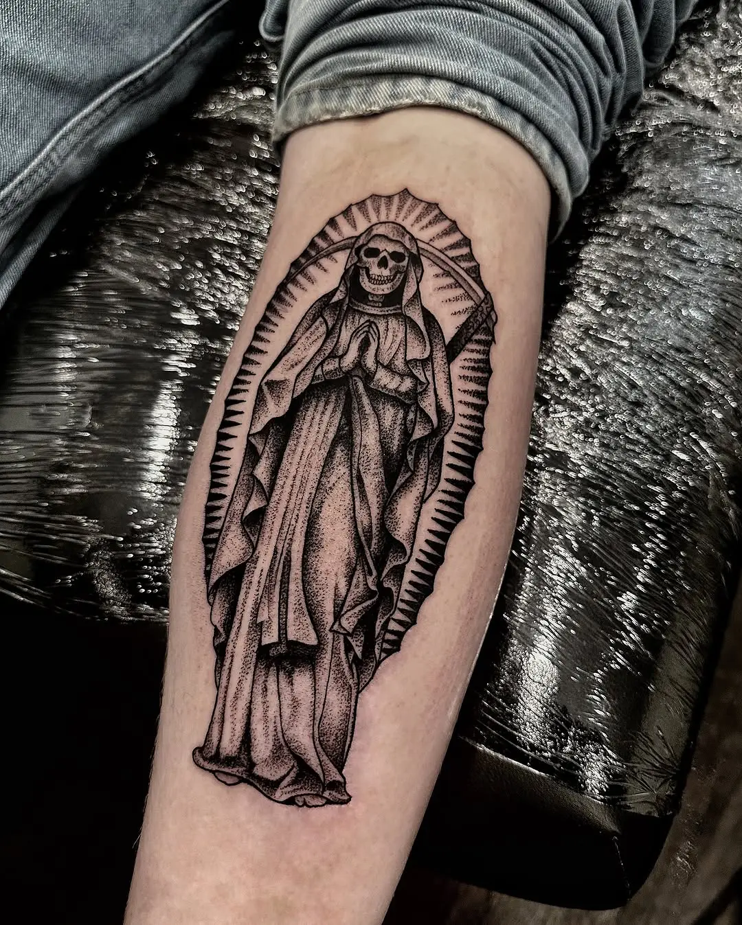 A praying Santa Muerte tattoo design