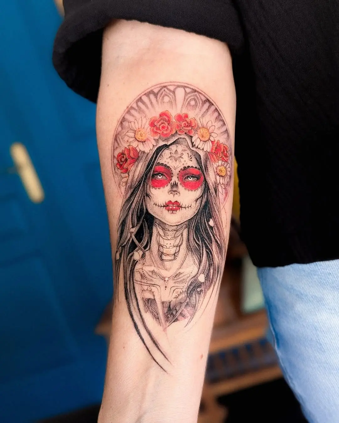 Intricate Santa Muerte tattoo with floral details