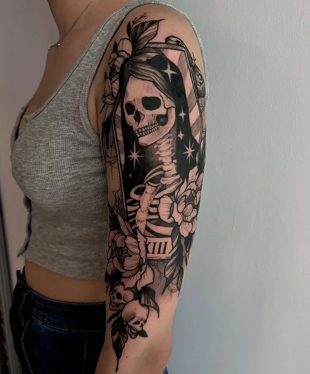 Bold Santa Muerte Tattoo with Floral Elements