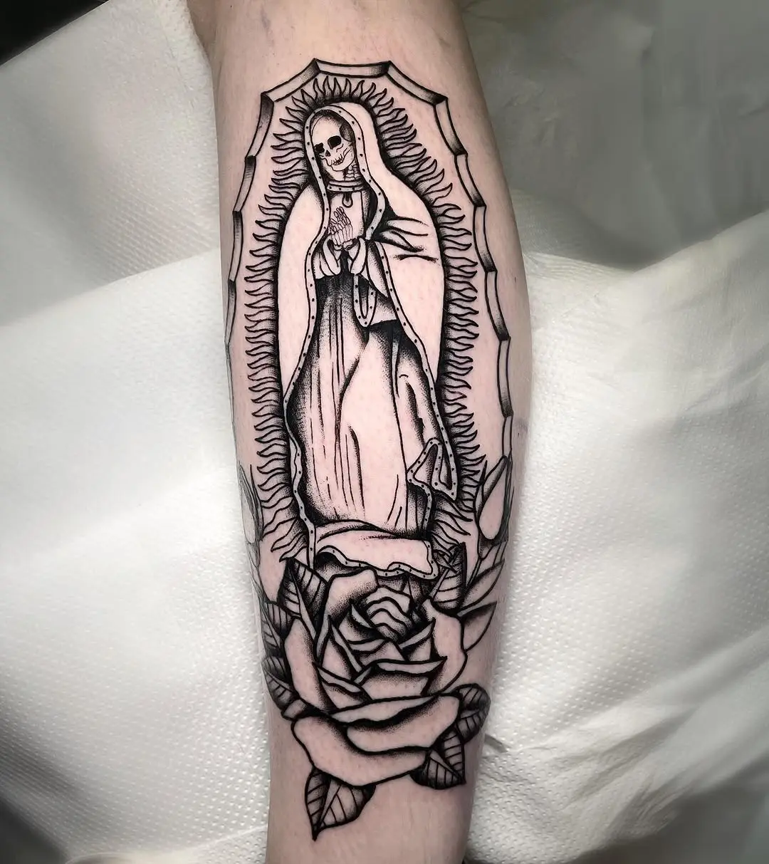Elegant Santa Muerte tattoo with roses design