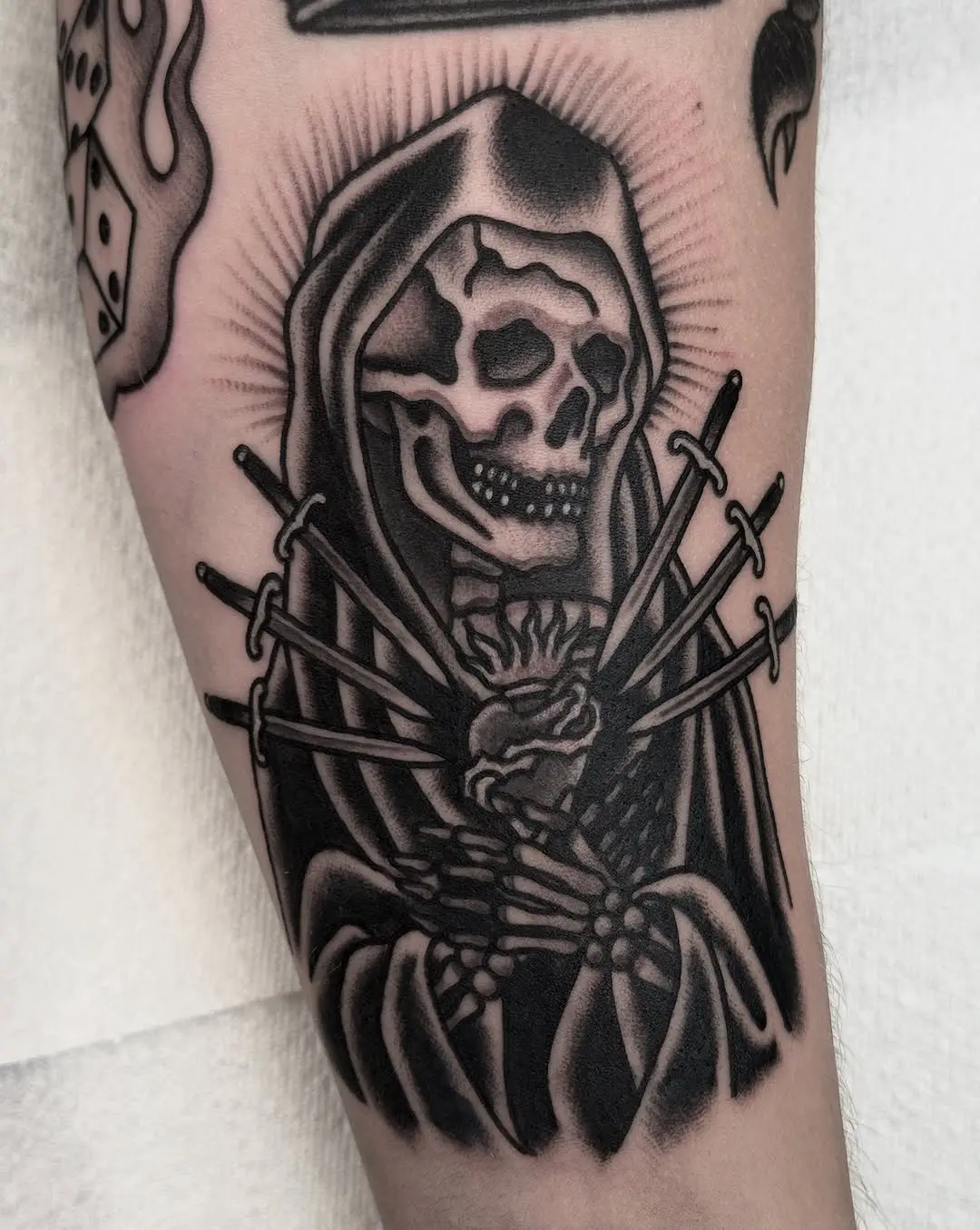 Intricate Santa Muerte tattoo with swords