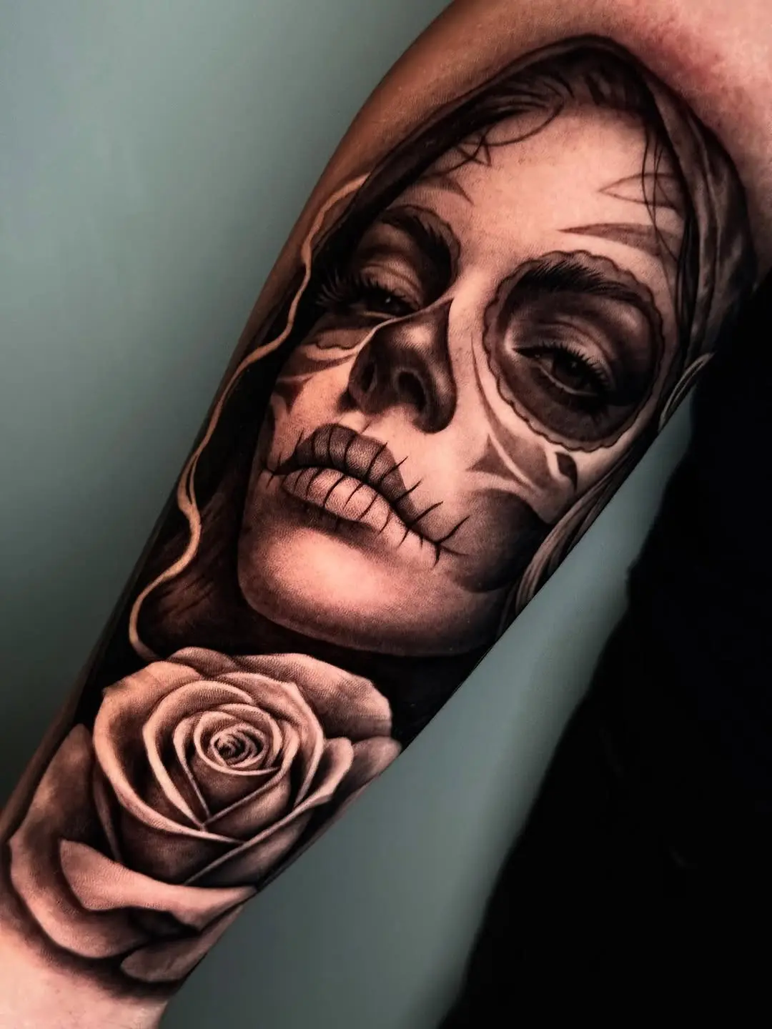 Intricate Santa Muerte tattoo with floral details