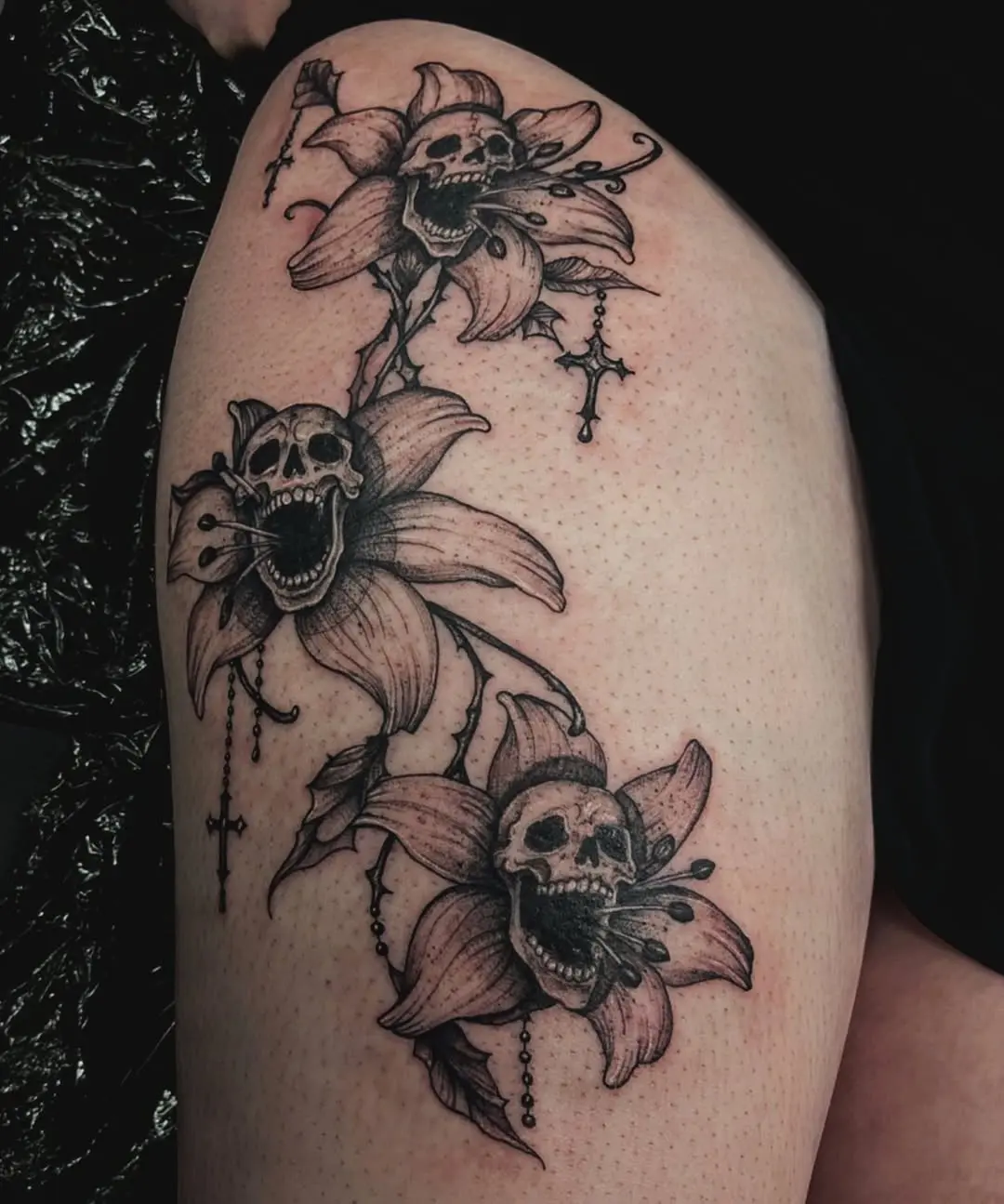 Intricate skull flower tattoo design on the thigh