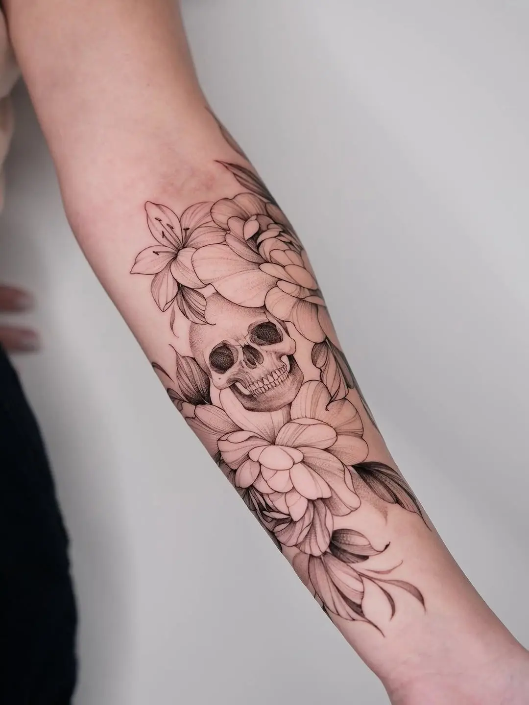 Intricate skull surrounded by delicate flowers