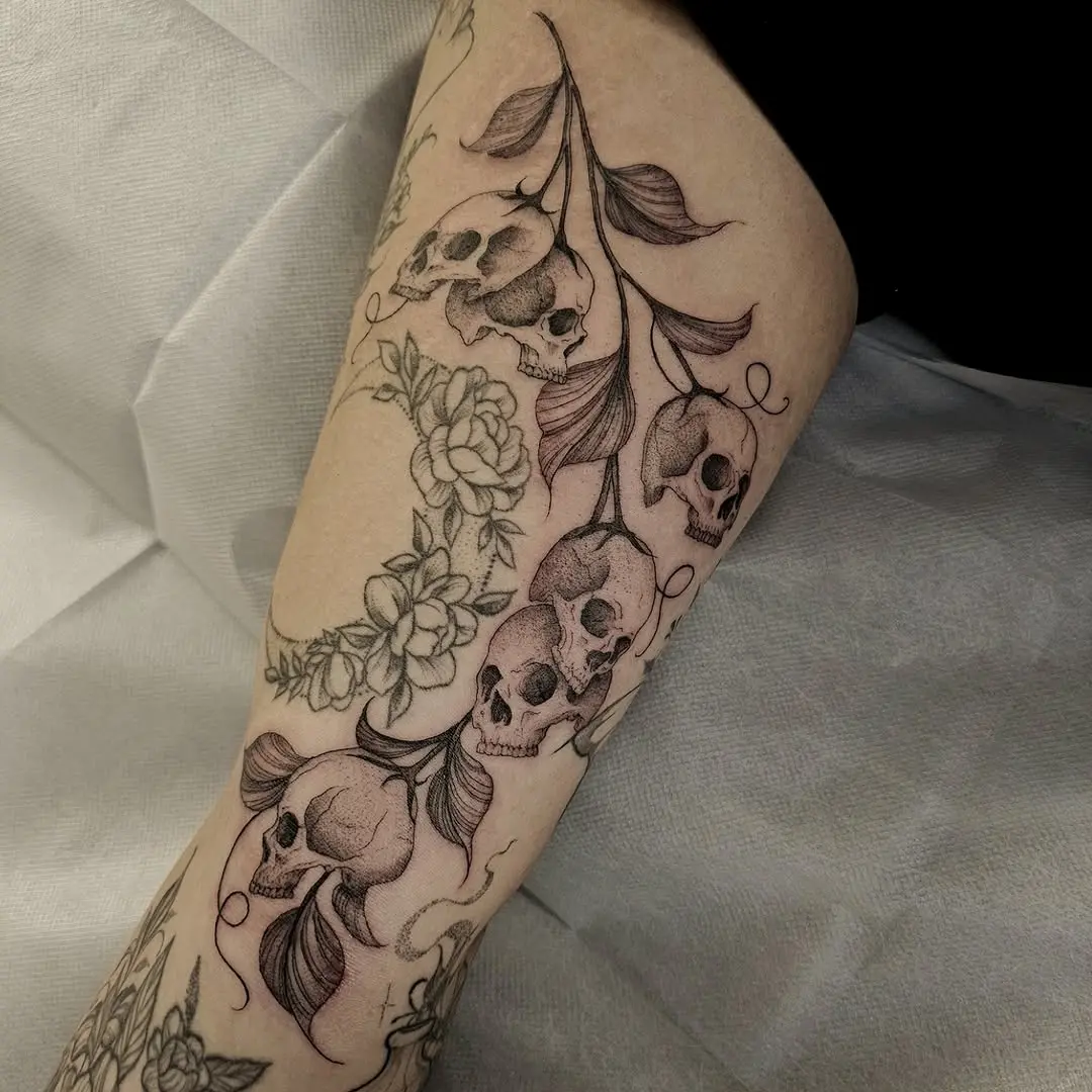 Intricate skull and floral tattoo design