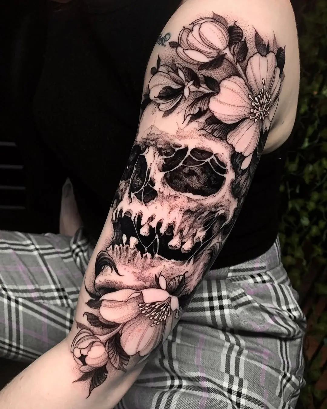 Stylish skull tattoo with floral accents