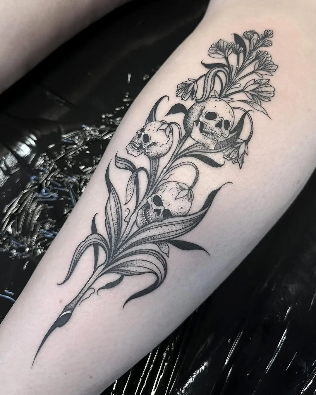 Intricate skull and flower tattoo design
