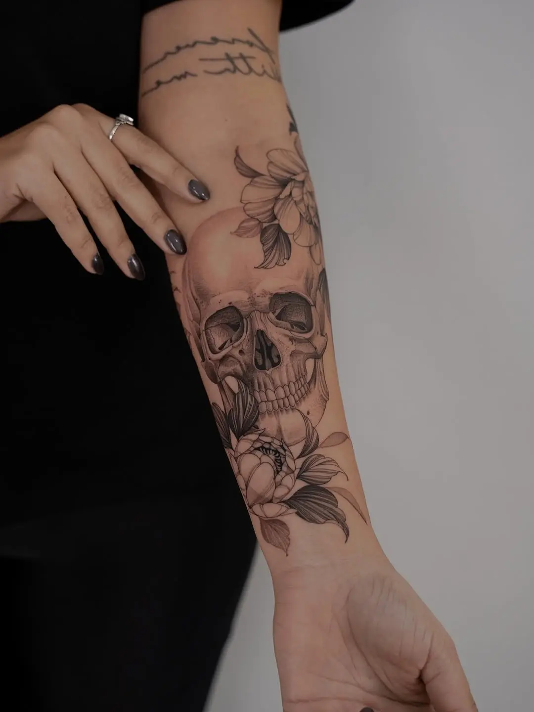 Elegant skull tattoo with floral elements