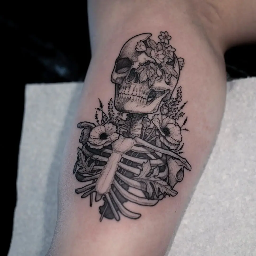Intricate floral skull tattoo design on skin