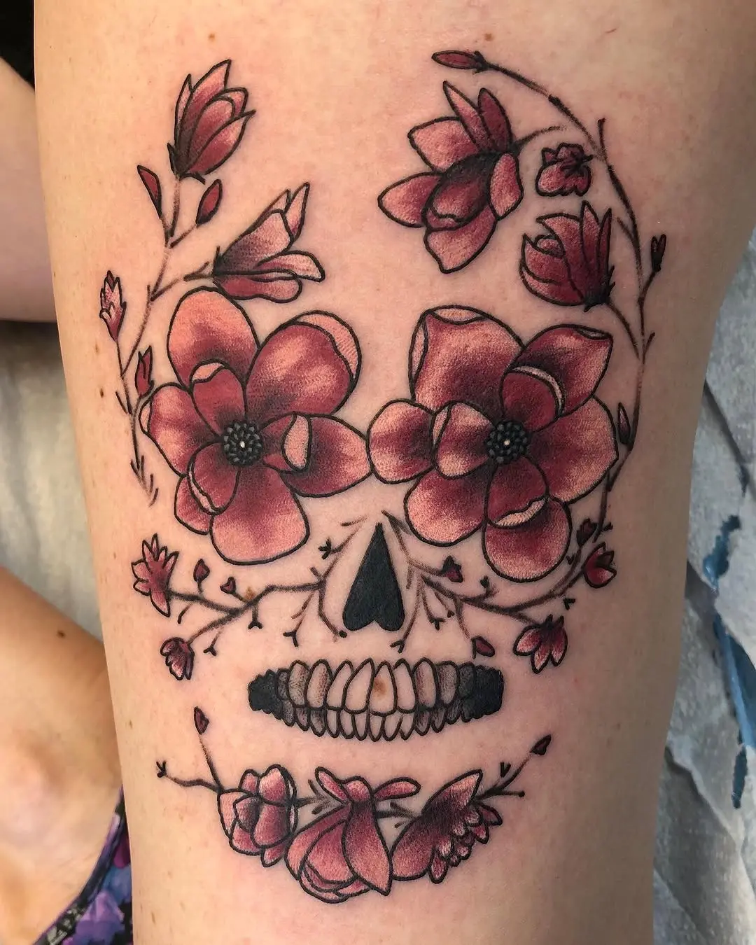 Beautiful floral skull tattoo blending nature and art