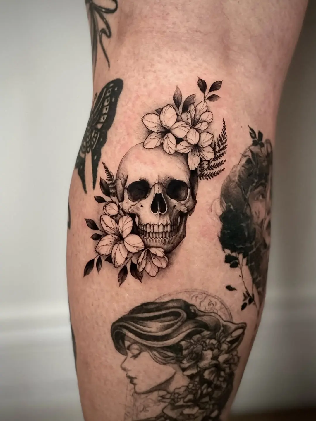 Elegant skull tattoo with floral accents