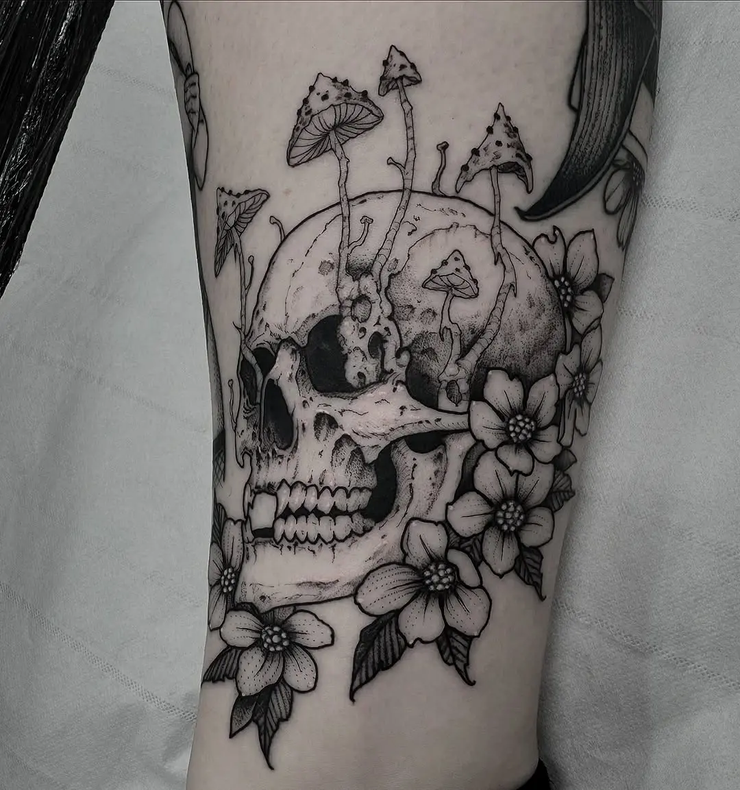 Intricate skull tattoo with botanical elements