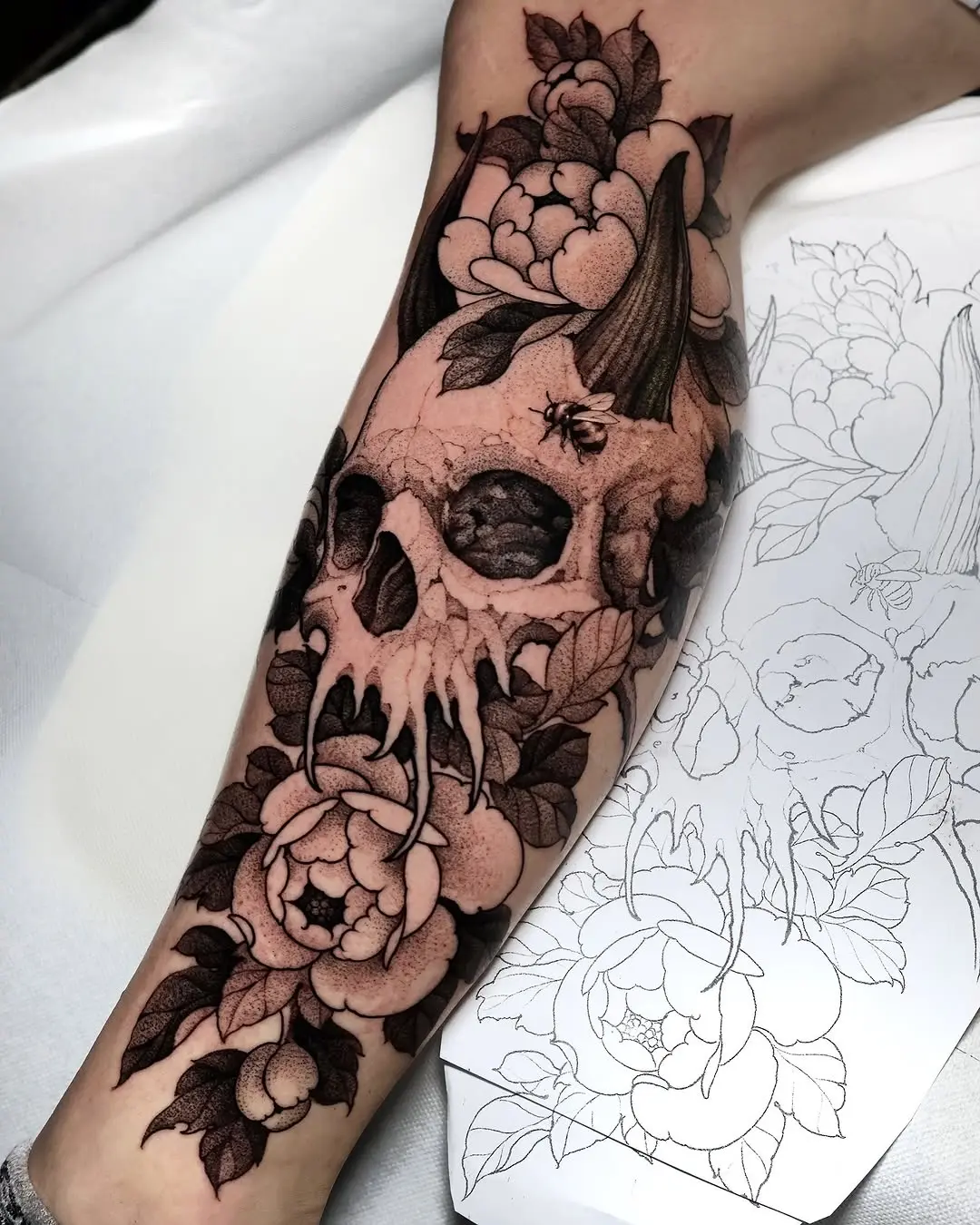 Intricate skull and floral tattoo design