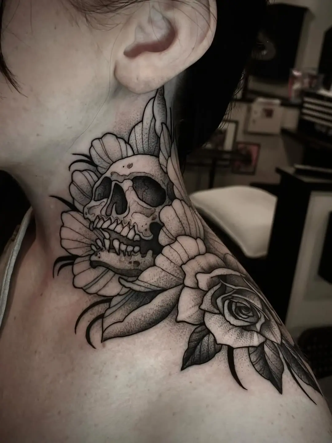 Intricate skull and flower neck tattoo design