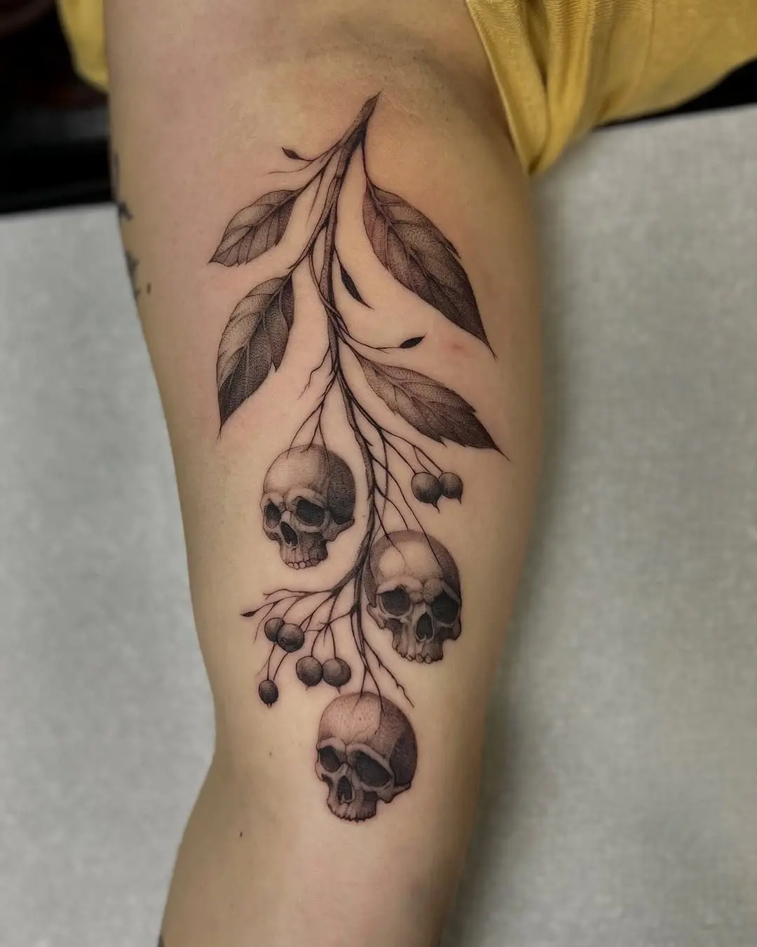 Elegant skulls intertwined with delicate leaves