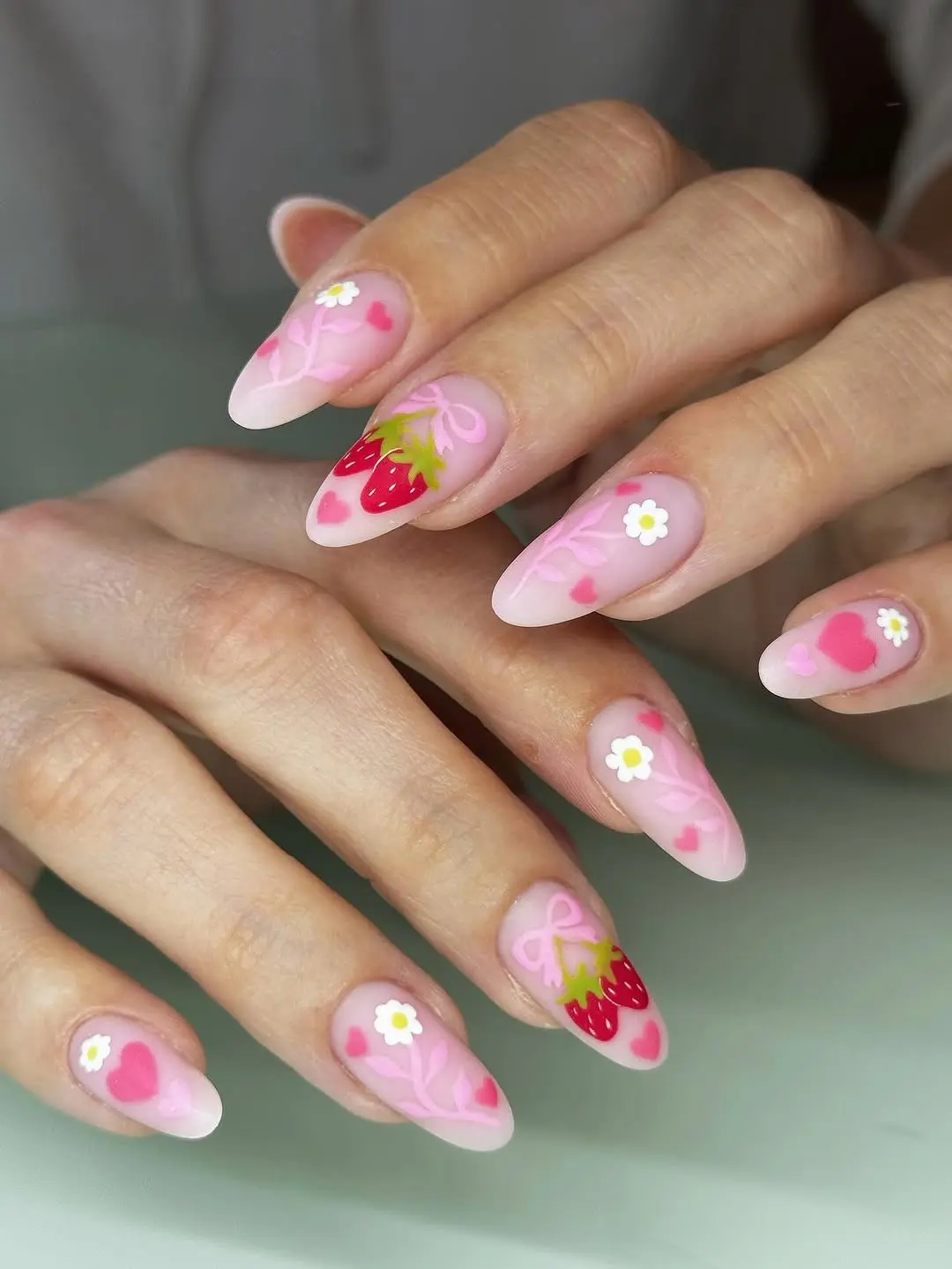 Charming strawberry-themed nail art design