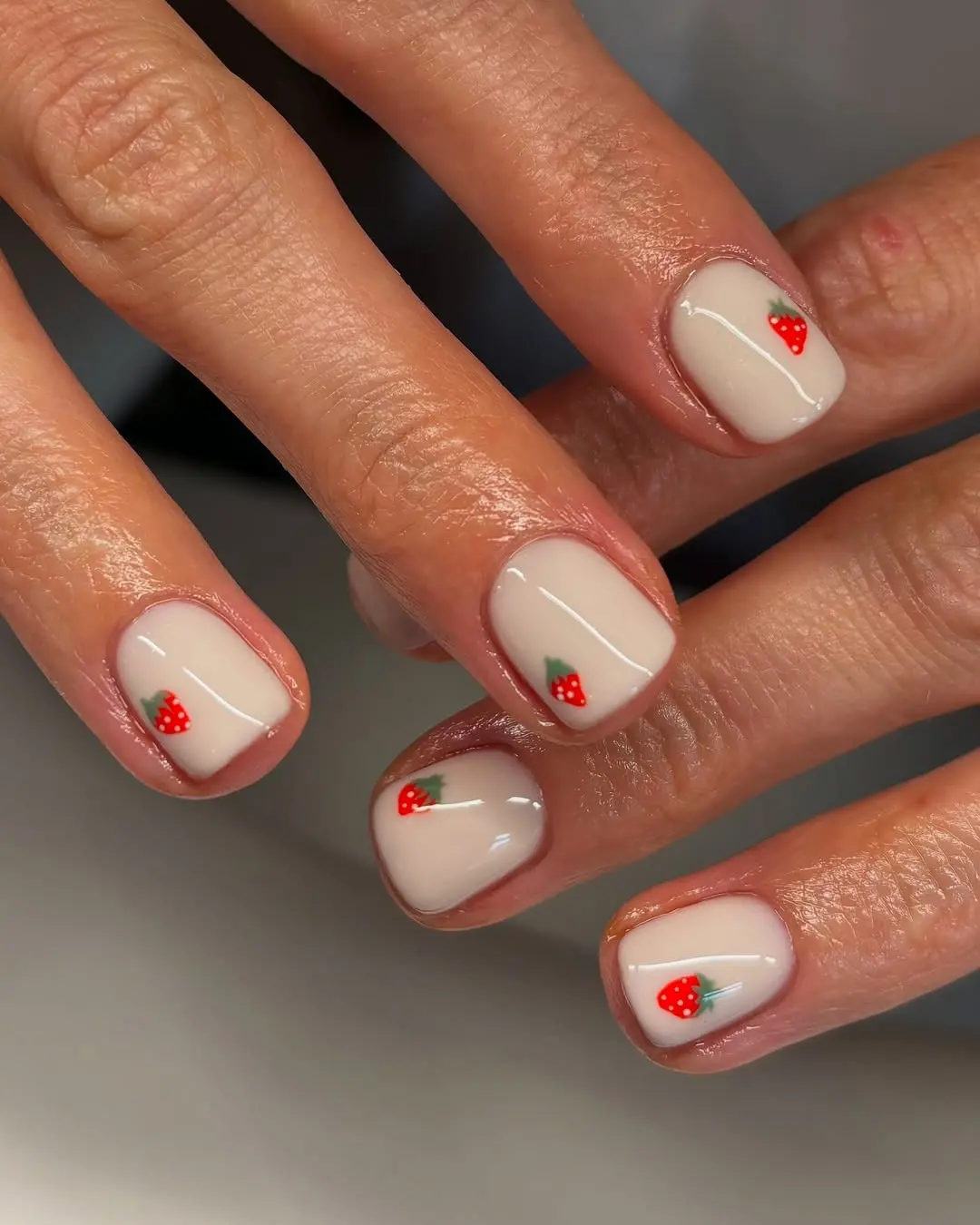 Charming strawberry design on nude nails