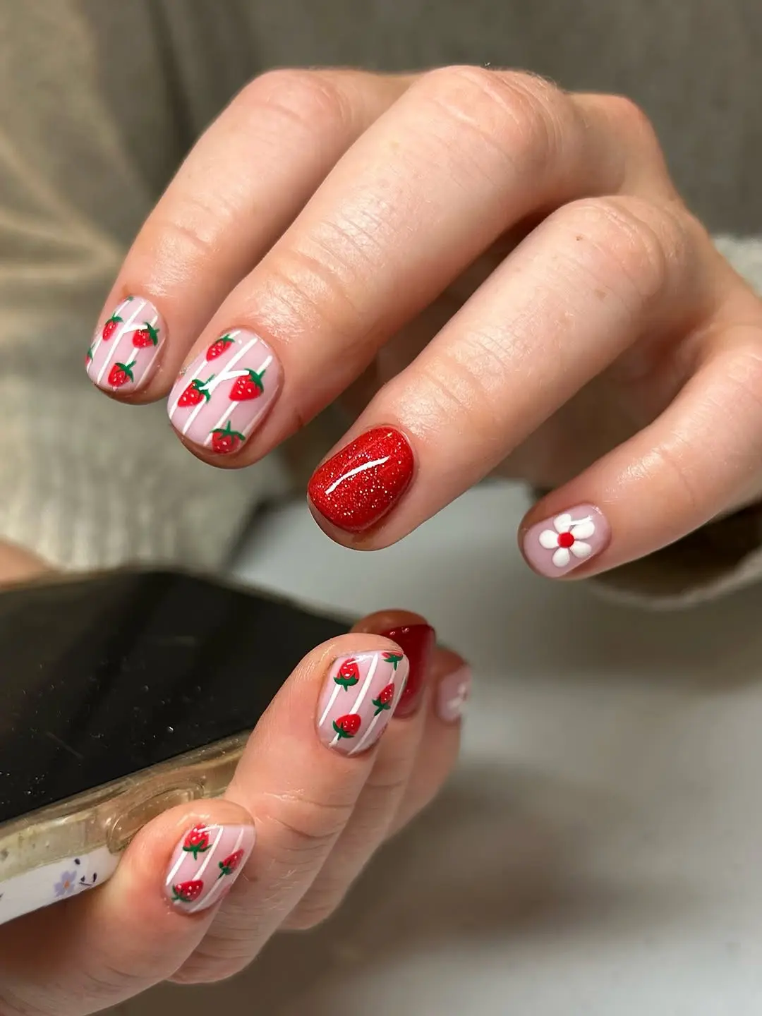 Charming strawberry-themed nail art for summer