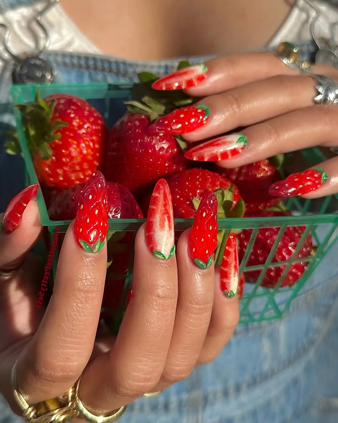 Vibrant strawberry-themed nail design with fruit