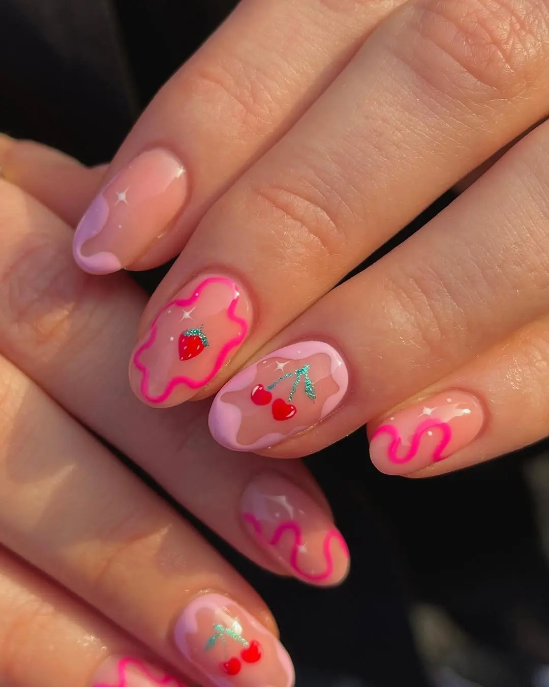 Charming strawberry-themed nail art design