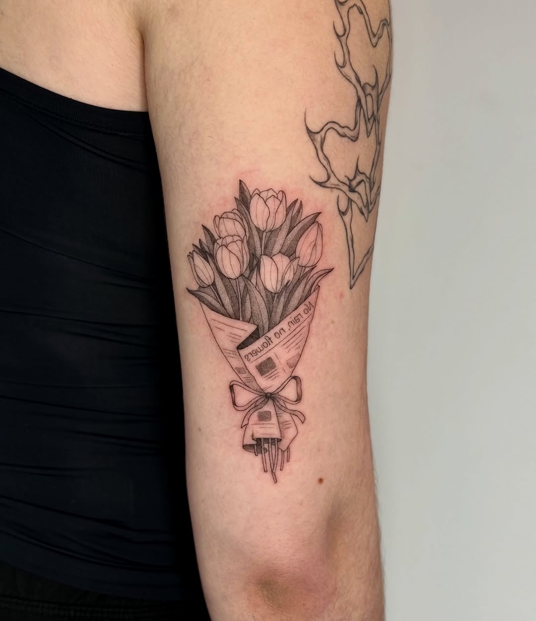 Elegant tulip bouquet tattoo in delicate line art