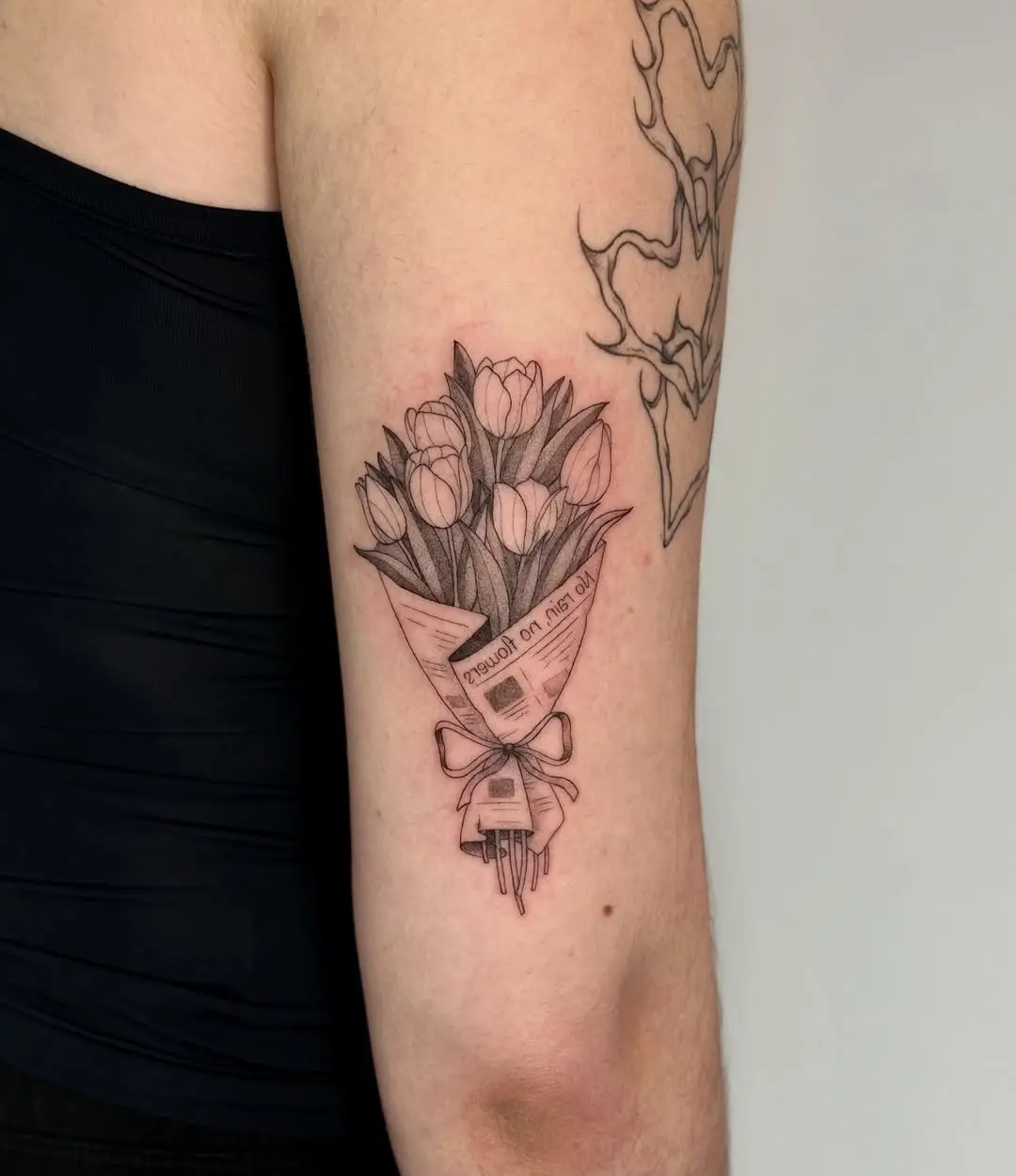 Elegant tulip bouquet tattoo in delicate line art