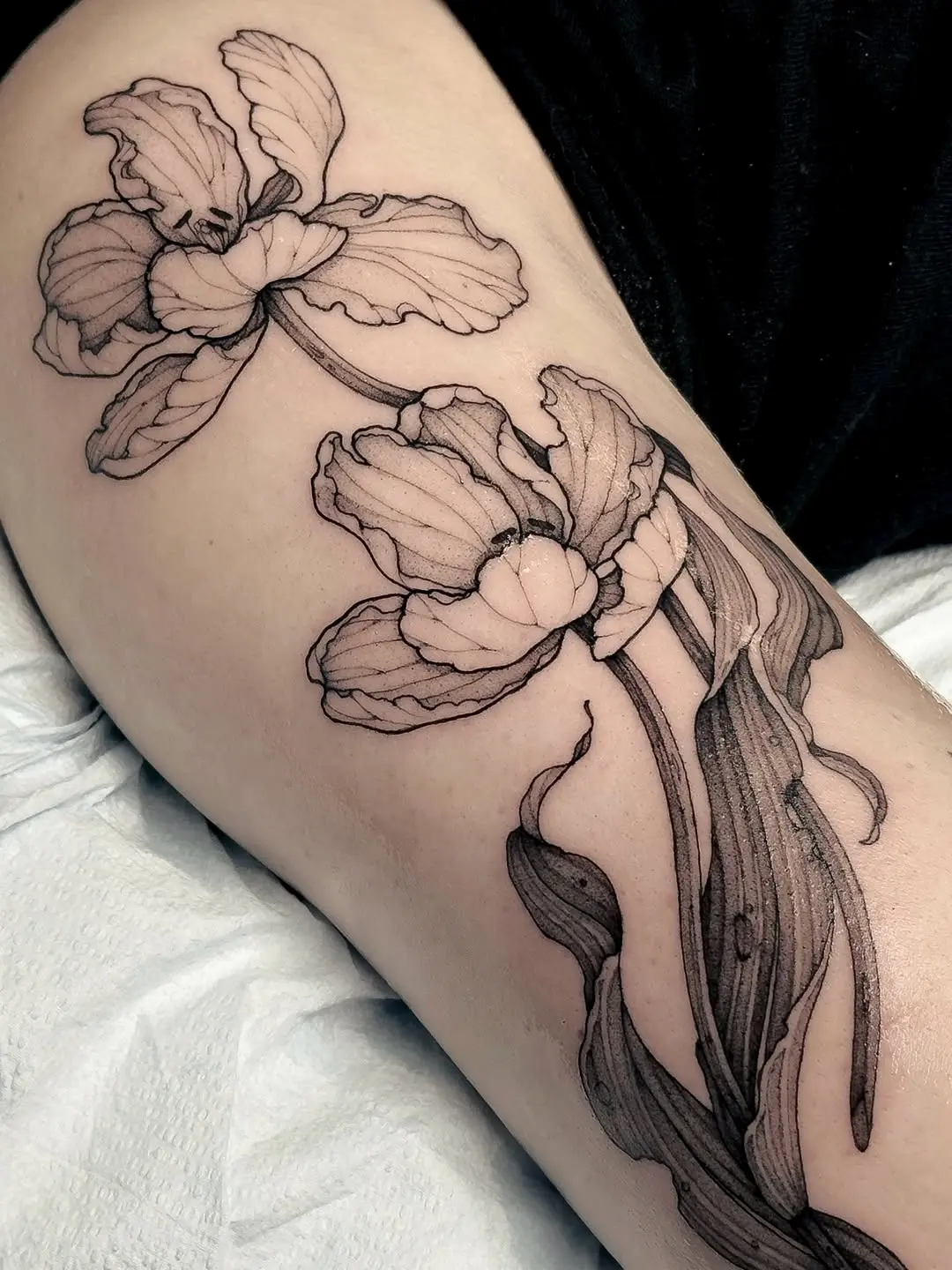 Elegant black ink tulip floral tattoo design