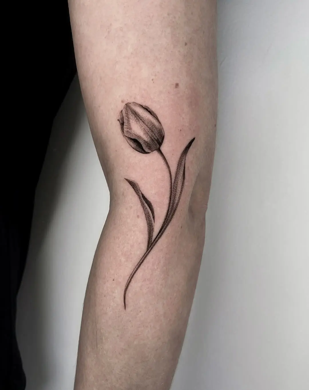 Elegant tulip tattoo floating on the skin
