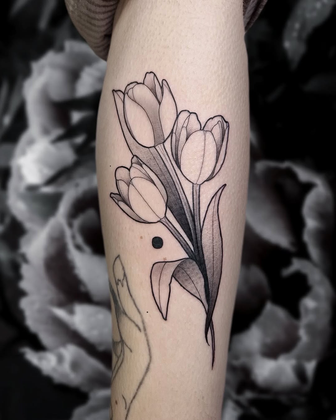 Elegant tulip tattoo design with subtle details