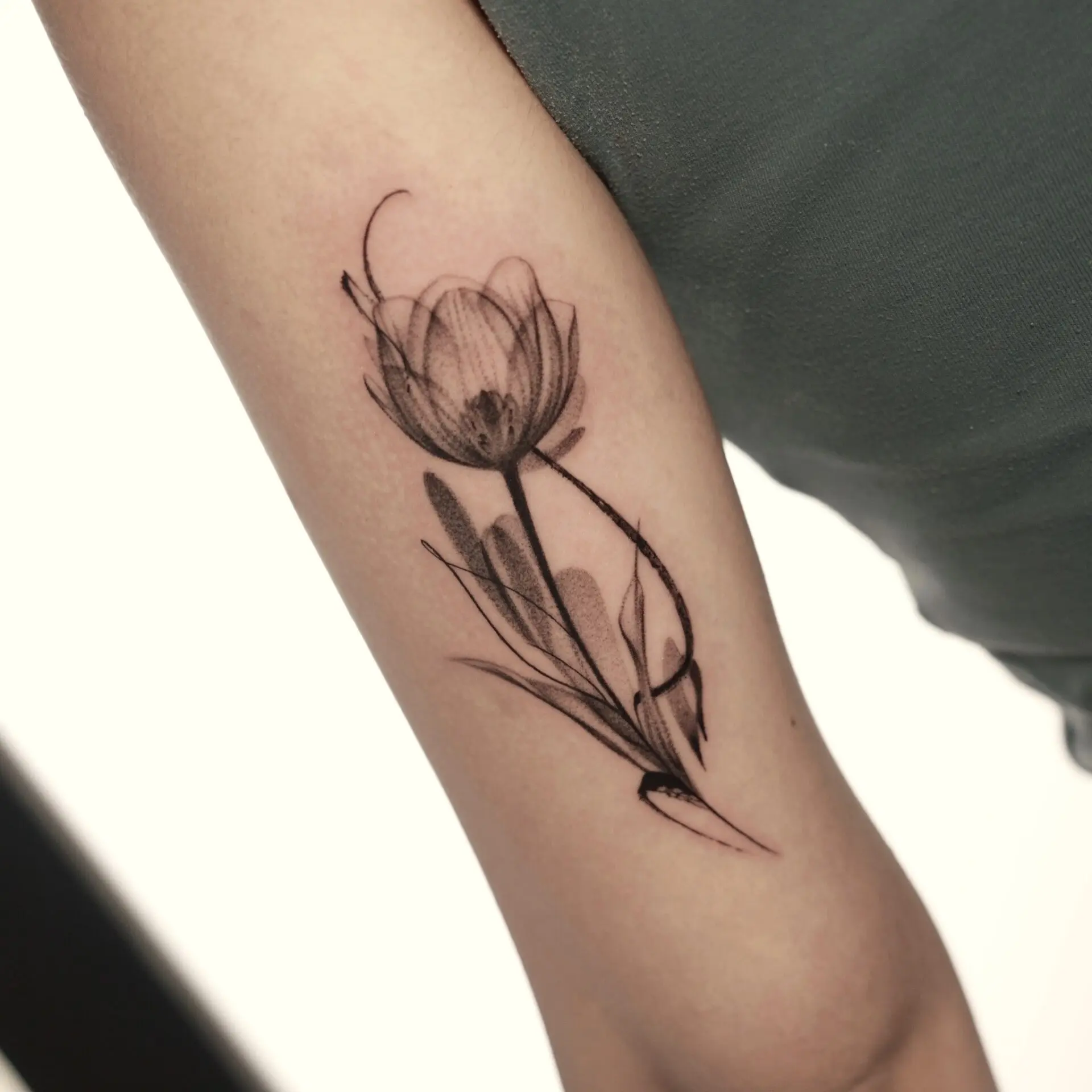 Elegant black and white tulip tattoo