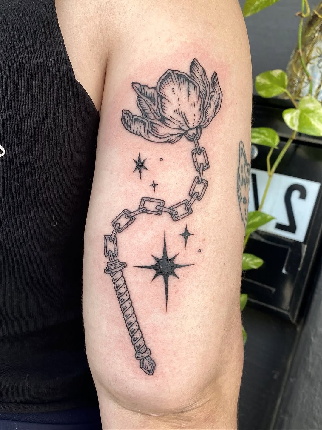 Elegant tulip tattoo entwined with chain design