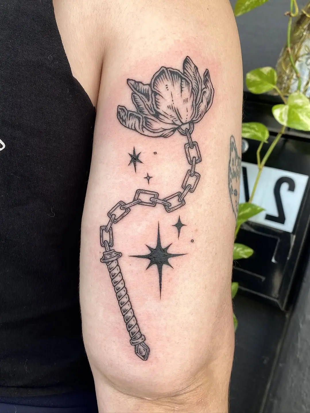 Elegant tulip tattoo entwined with chain design