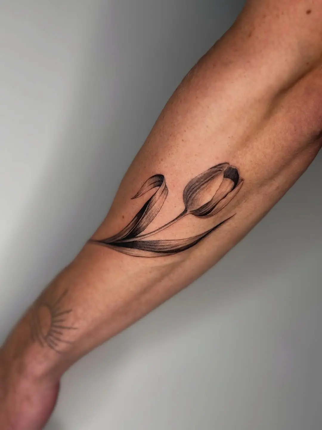 Elegant tulip tattoo showcasing minimalist line art
