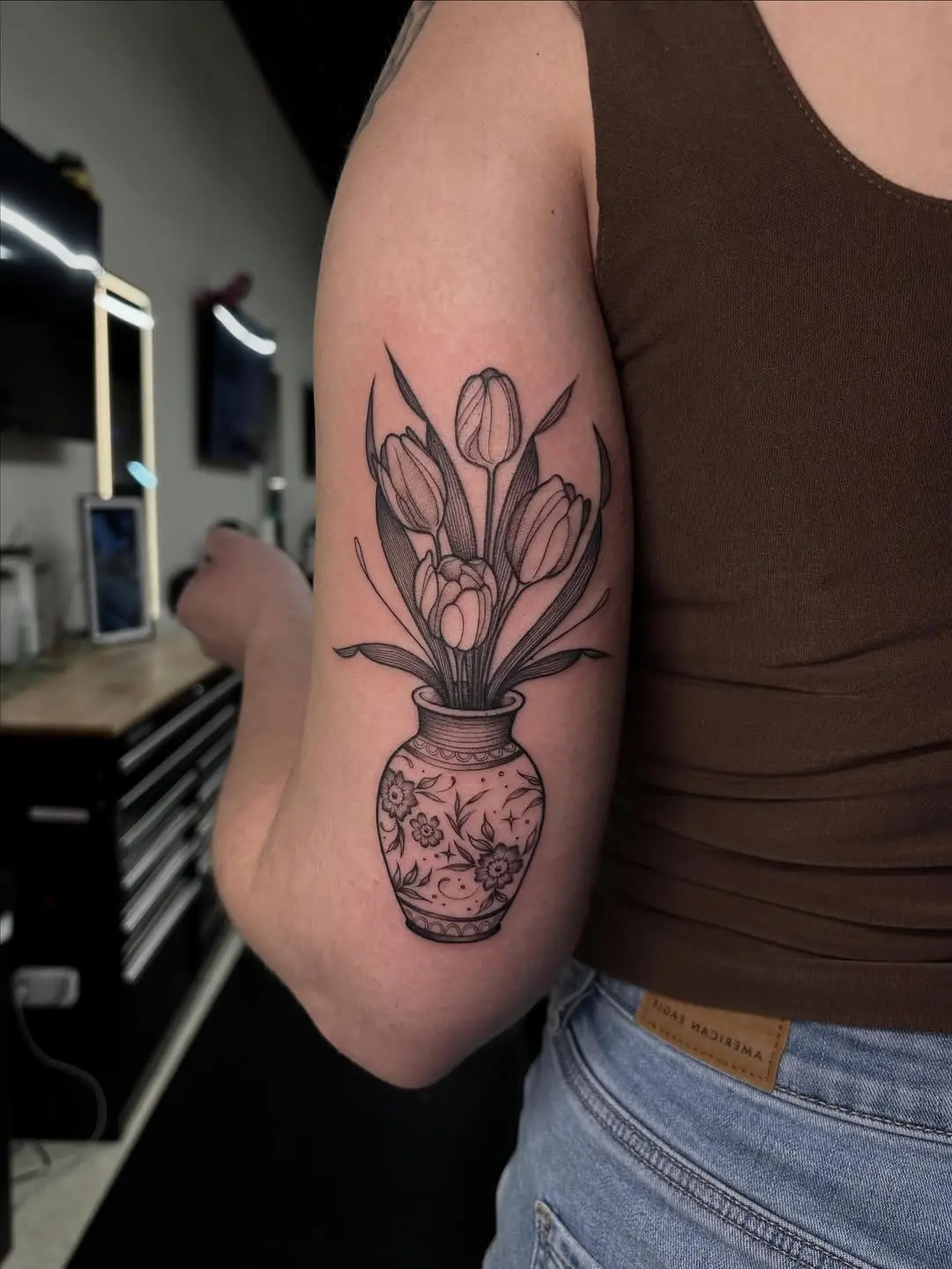 Elegant tulip tattoo in a charming vase