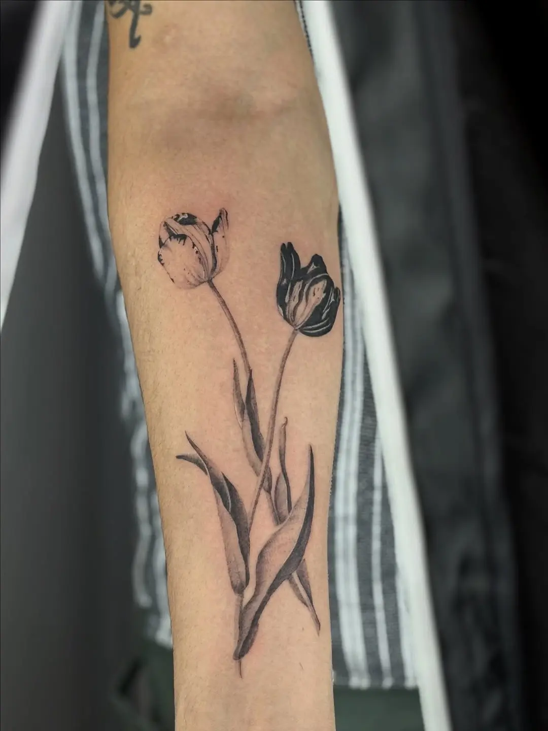 Stylish black and white tulip tattoo design