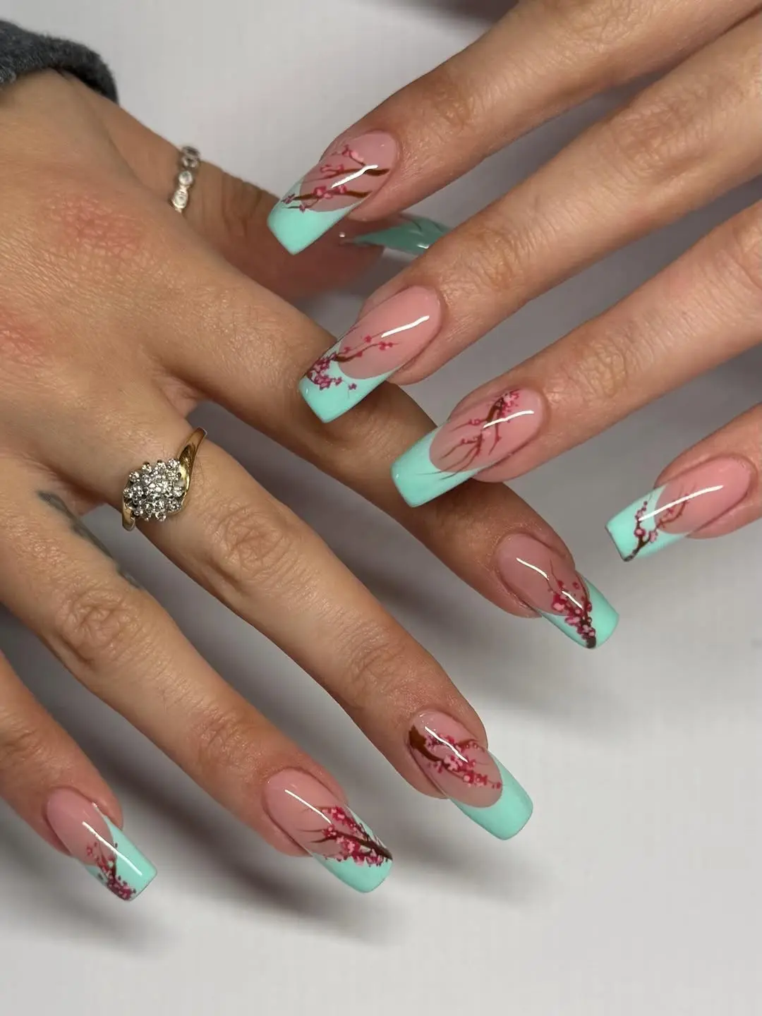 Elegant turquoise french tips with floral accents
