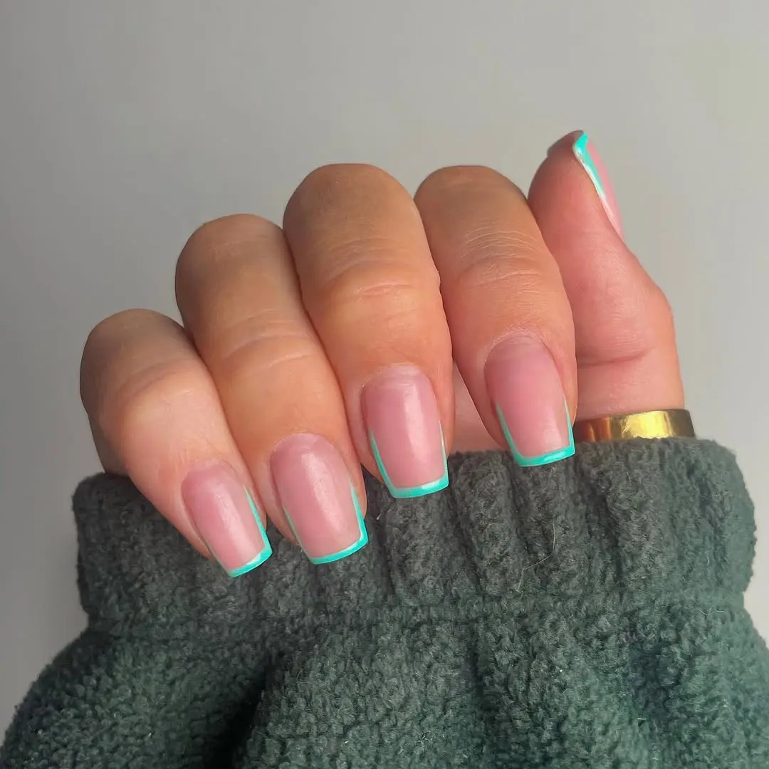 Trendy turquoise french tip nail design captured