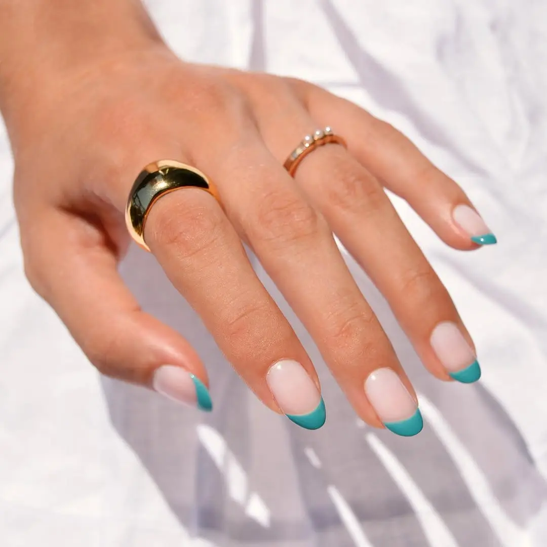 Stylish turquoise tips complement natural nails