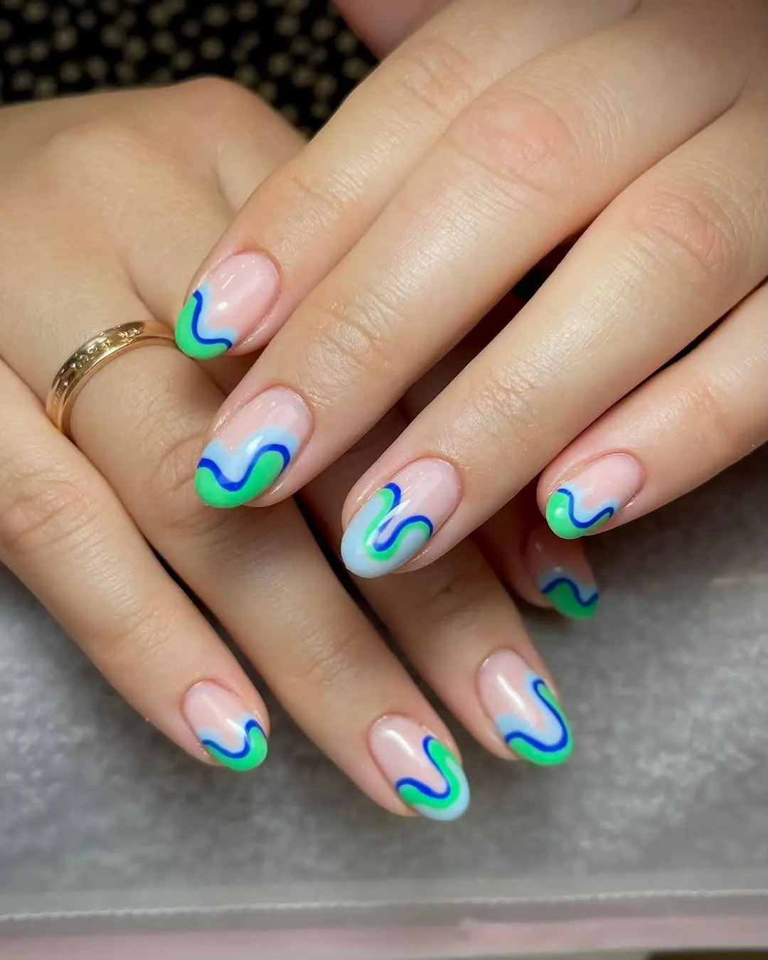 Vibrant turquoise wave French tip nail design