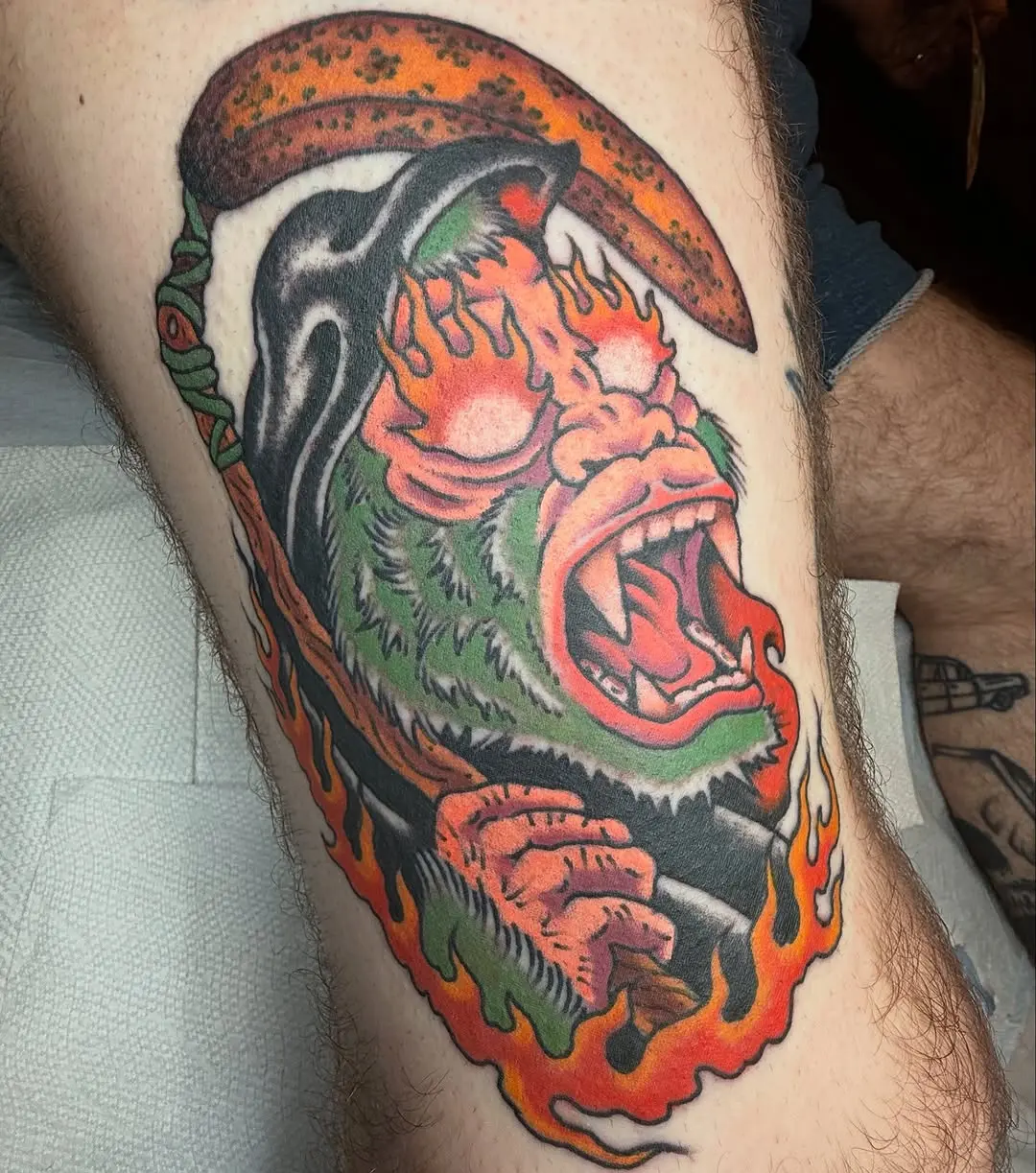 A bold gorilla tattoo with fiery elements