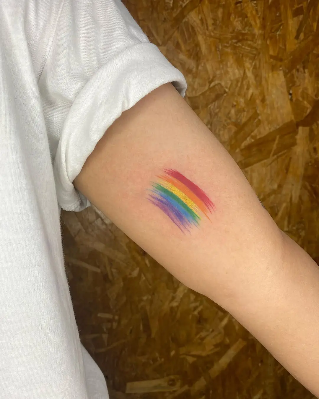 Colorful rainbow tattoo on arm