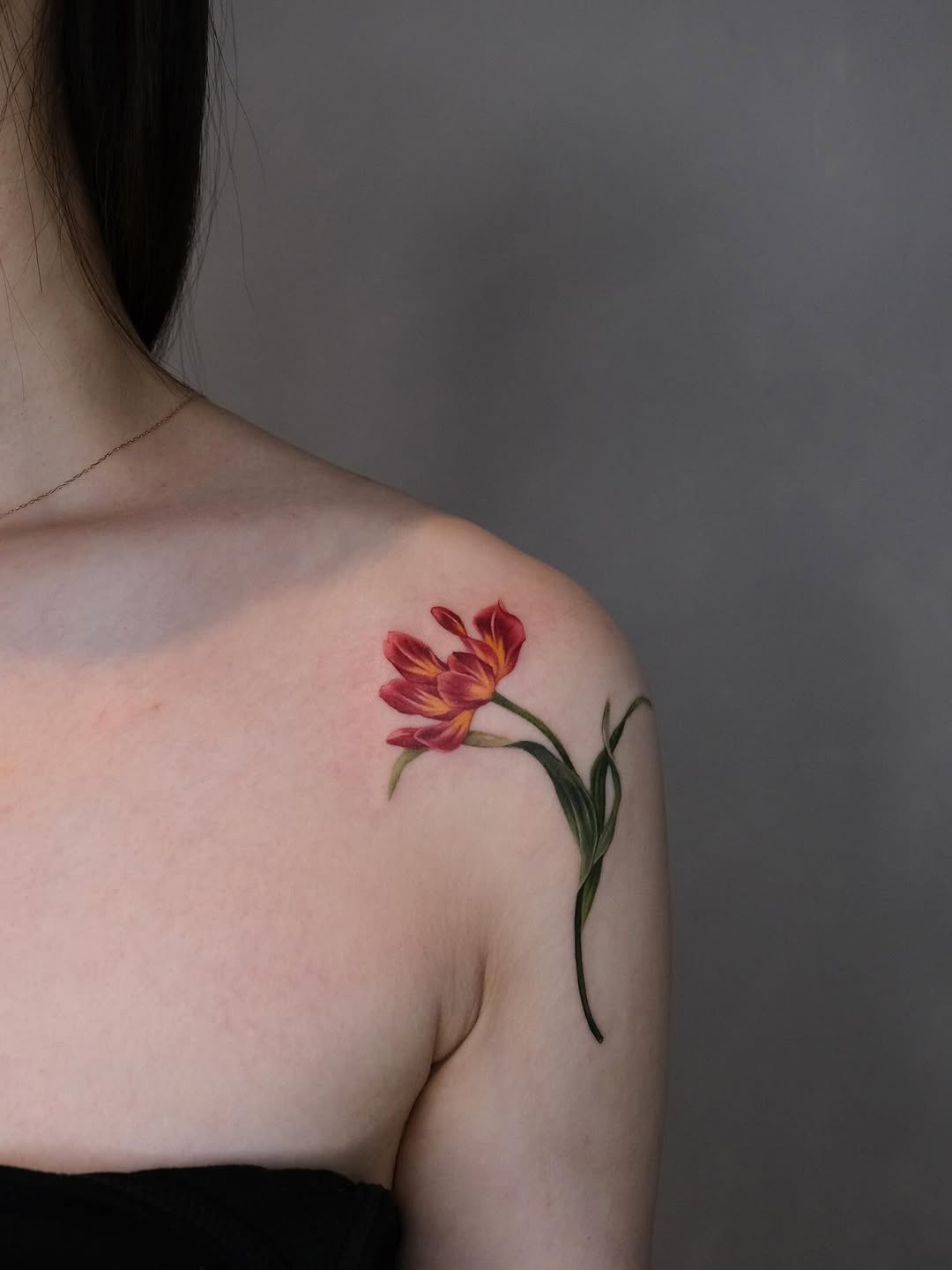 Elegant tulip tattoo on shoulder showcasing beauty