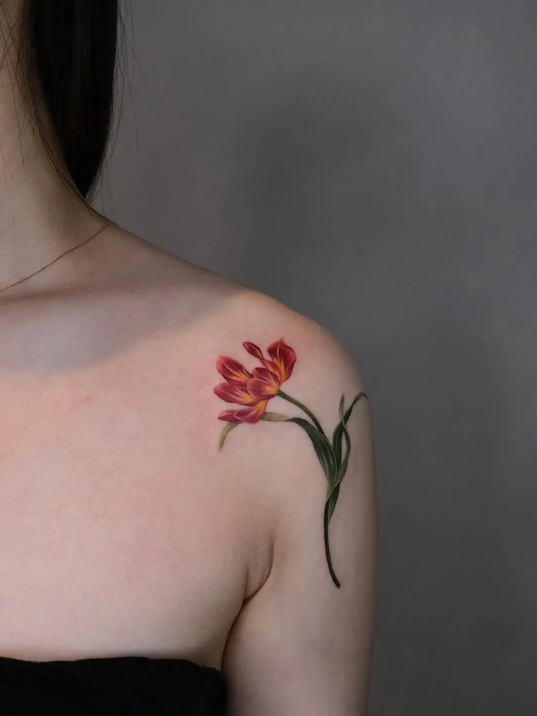 Elegant tulip tattoo on shoulder showcasing beauty