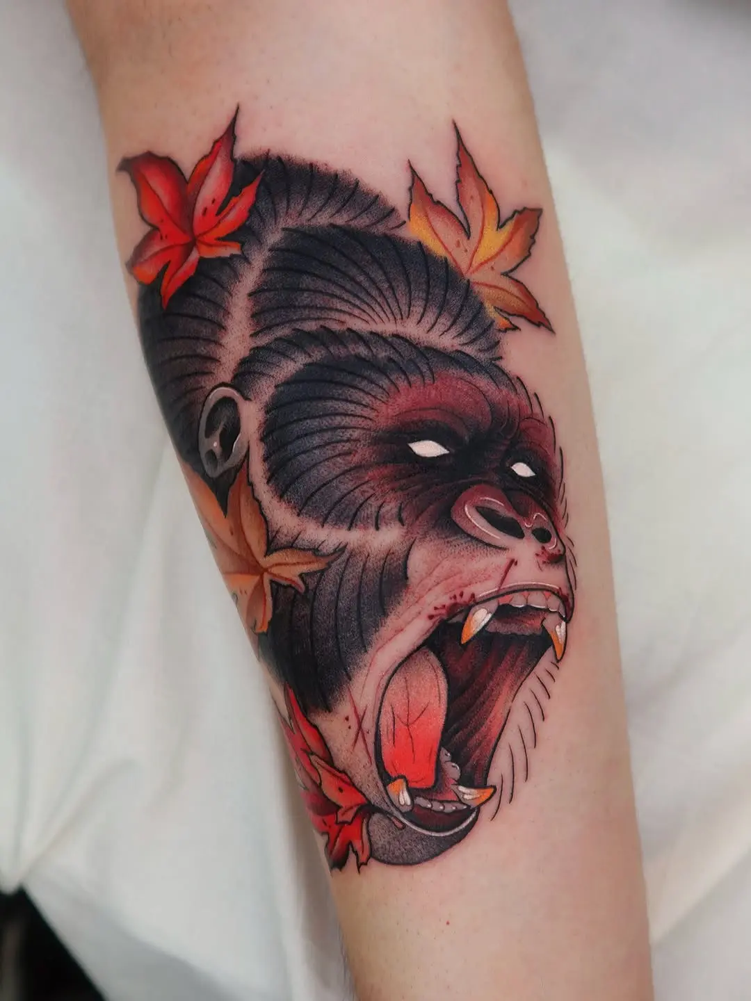 Fierce Gorilla Tattoo with Vibrant Autumn Leaves