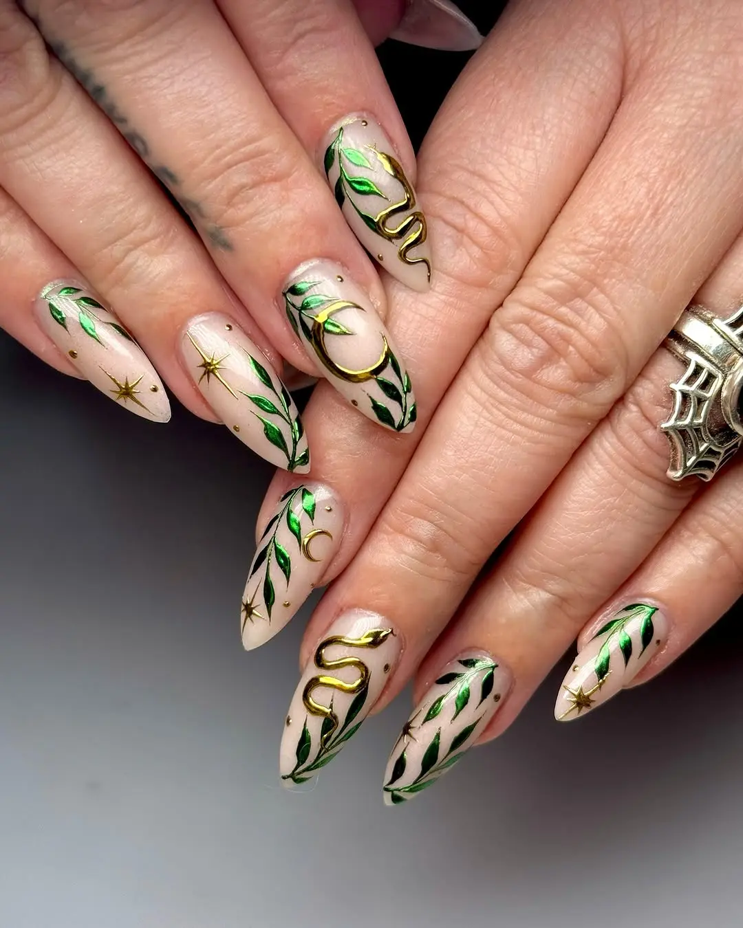 Elegant witchy nails with gold and green accents