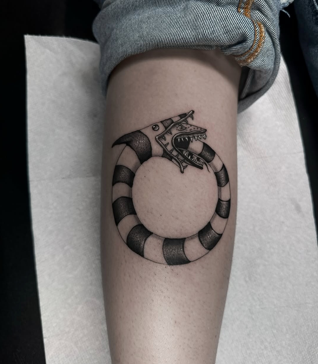 Creative Beetlejuice-inspired Snake Tattoo Design